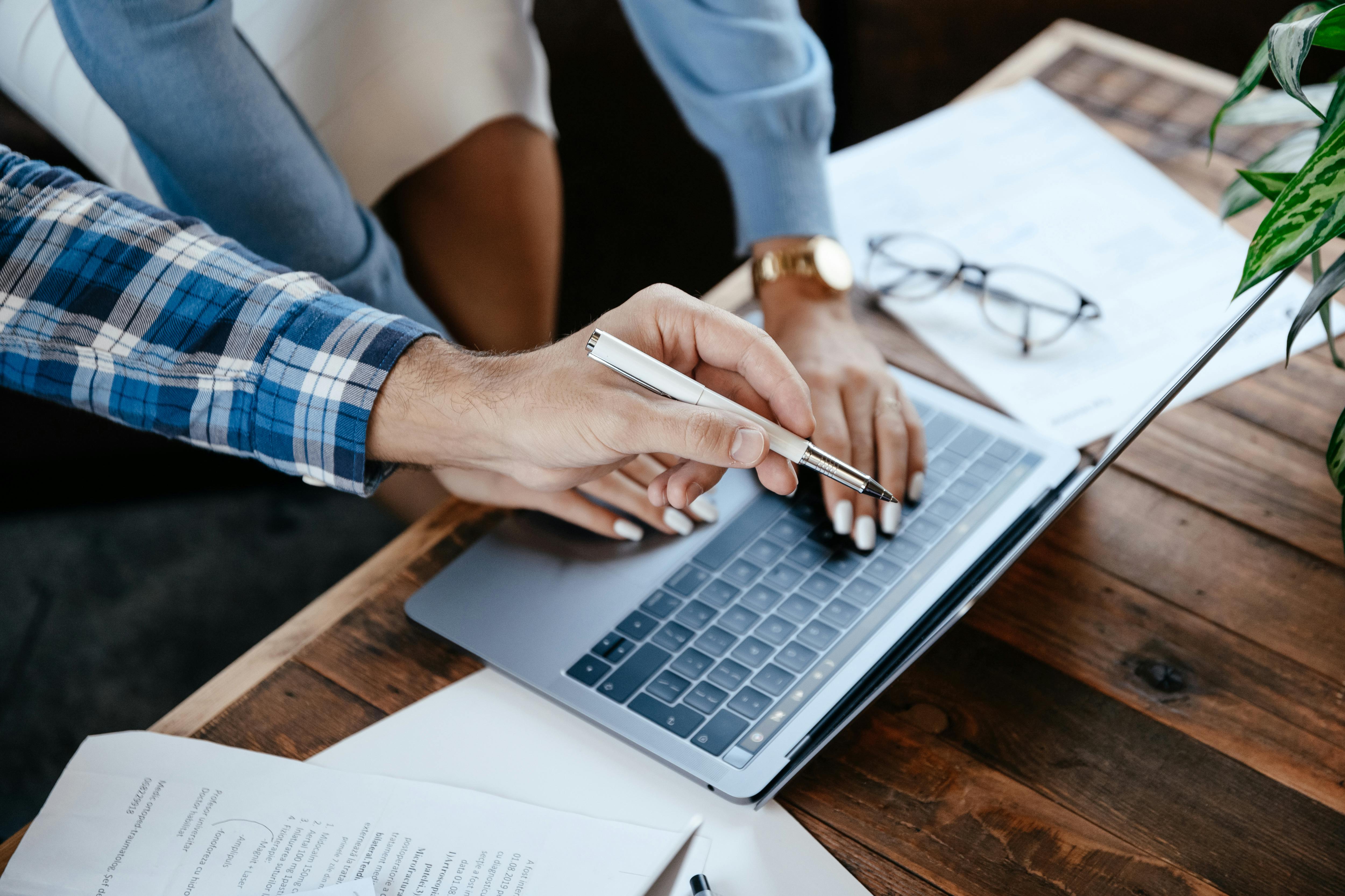 two people looking at a document on a laptop