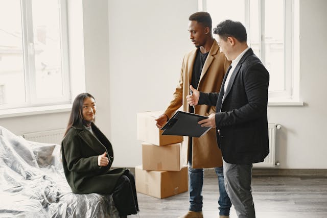 pexels-gustavo-fring-7489094 couple-with-real-estate-agents-holding-a-clipboard