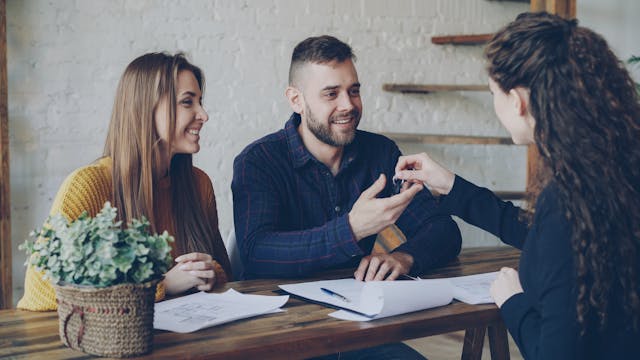 pexels-silverkblack-36729675 couple-being-handed-keys-to-home-by-real-estate-agent